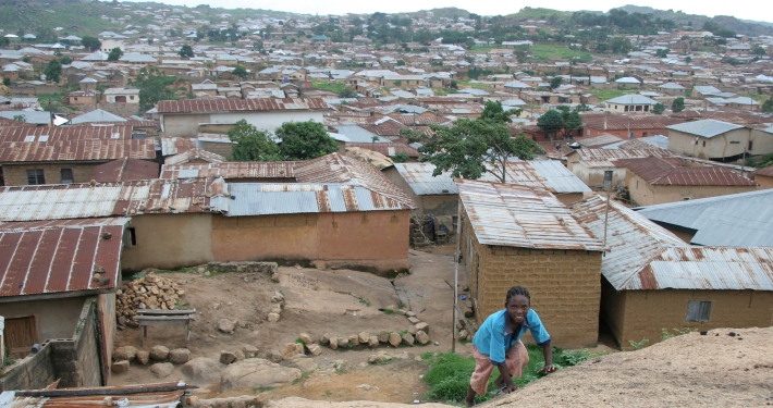 View of a town in northern Nigeria with a young boy in the foreground
